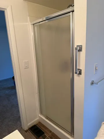 a bathroom with a glass shower door