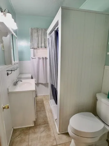 a bathroom with a sink a toilet and mirror