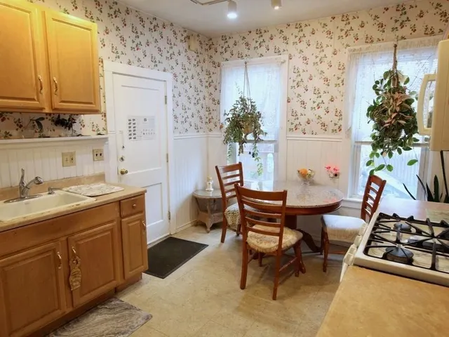 a view of a kitchen area with furniture and wooden floor