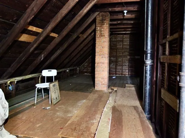 a yellow house with trees in front of it