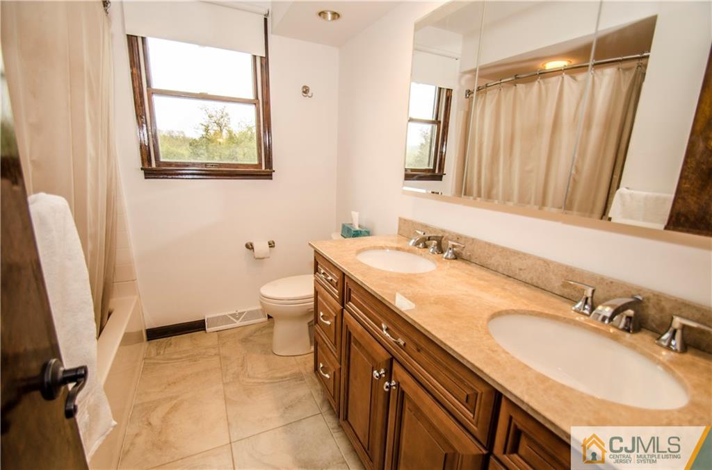 29 Yard Road Pennington, NJ 08534 - Photo 15 of 25 a bathroom with a sink a toilet and a mirror