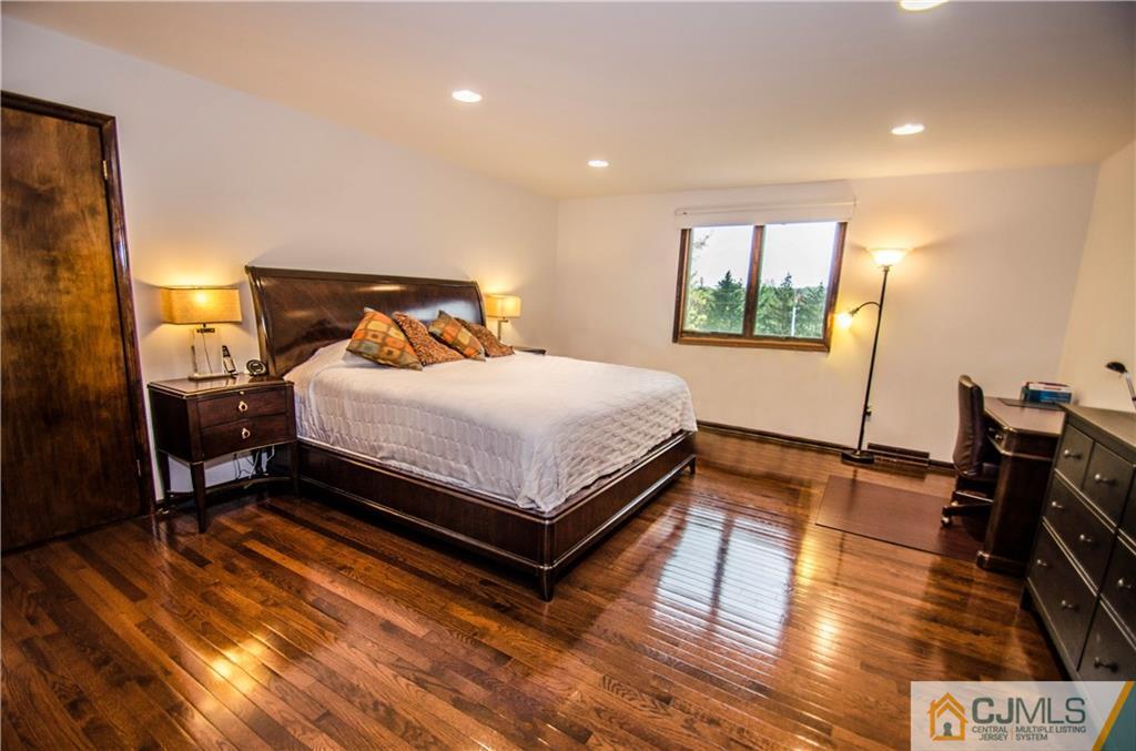 29 Yard Road Pennington, NJ 08534 - Photo 16 of 25 a bedroom with a bed and wooden floor