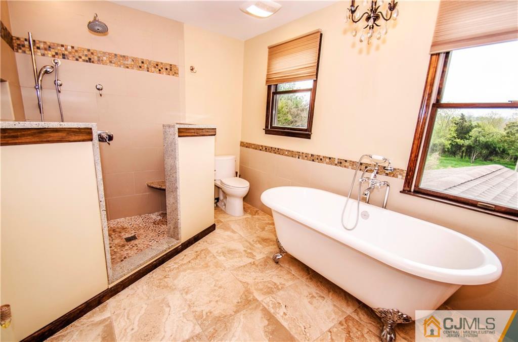 29 Yard Road Pennington, NJ 08534 - Photo 19 of 25 a bathroom with a tub a sink and a window