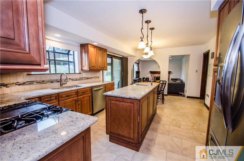 29 Yard Road Pennington, NJ 08534 - Photo 6 of 25 a kitchen with stainless steel appliances granite countertop a sink stove and refrigerator