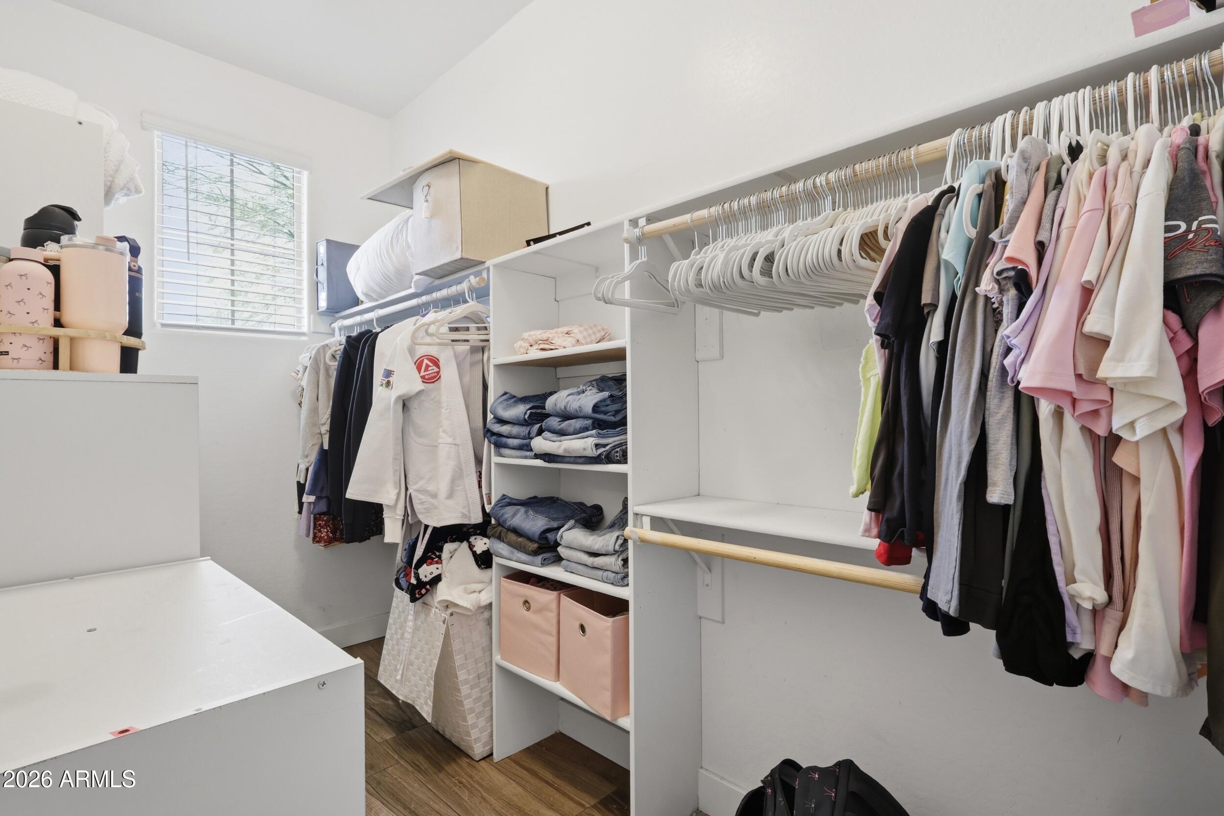 12517 West Lawrence Road Glendale, AZ 85307 - Photo 40 of 52 a view of walk in closet with clothes and shoes