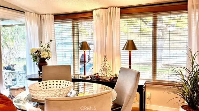 a view of a dining room with furniture and a window