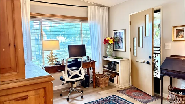 a view of a livingroom with workspace and a window