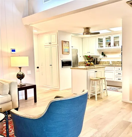 a living room with stainless steel appliances kitchen island granite countertop furniture and a kitchen view