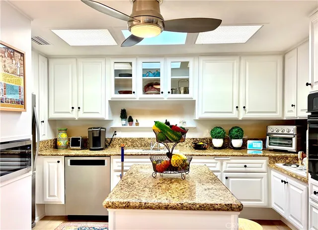 a kitchen with a stove a sink and a refrigerator
