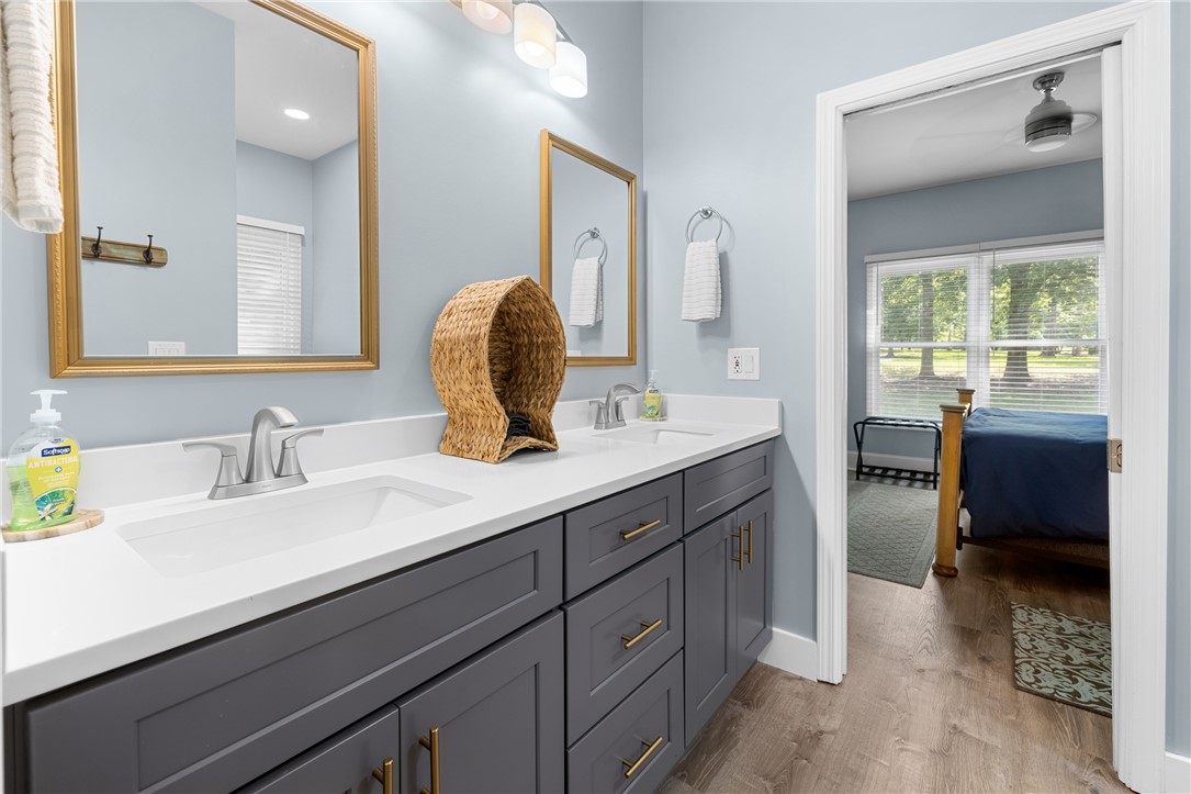 206 Petty Road Seneca, SC 29672 - Photo 25 of 47 Double vanity with sleek gray cabinetry and gold hardware offers both style and convenience.