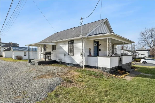 a house view with swimming pool in front of it
