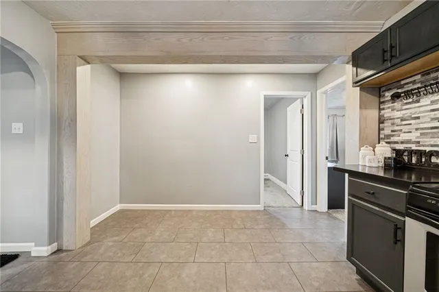 a view of a kitchen with a sink and refrigerator