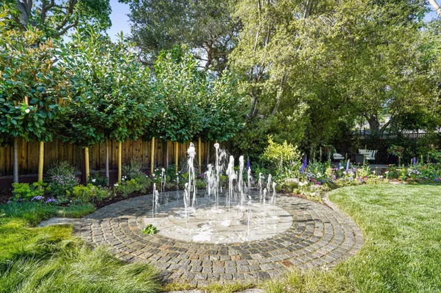 a white bath tub sitting in a bathroom next to a window