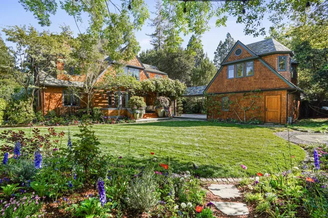 a living room with furniture fireplace and a large window