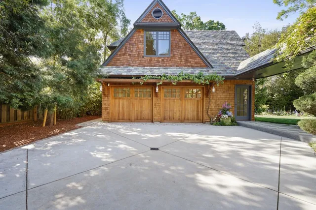 a living room with large windows and wooden floor