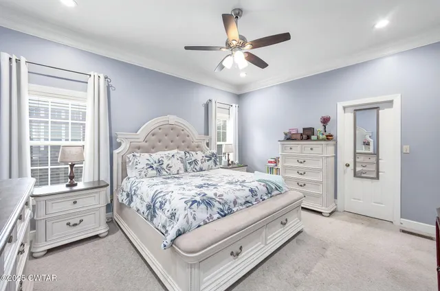 a spacious bedroom with a bed and a chandelier