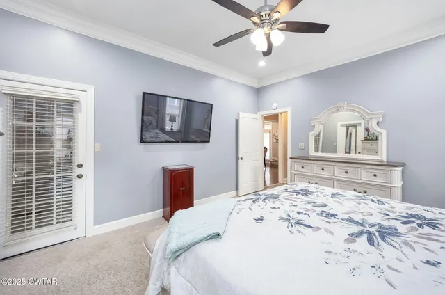 a bedroom with a large bed and a flat screen tv