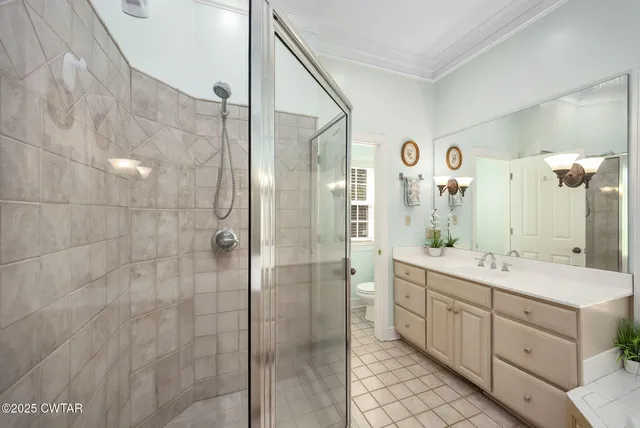 a bathroom with a double vanity sink mirror and shower