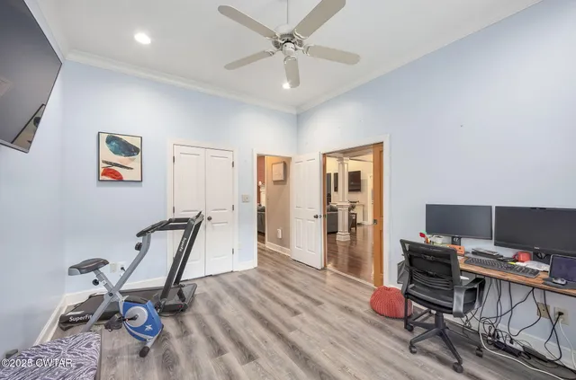 a view of a workspace with furniture and wooden floor