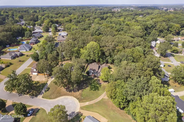 an aerial view of a house with a yard