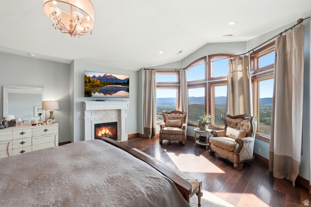 335 Bern Way Midway, UT 84049 - Photo 31 of 88 Spacious room featuring extensive picture windows, a decorative fireplace with a mantel, dark wood-finish flooring, and a contemporary chandelier