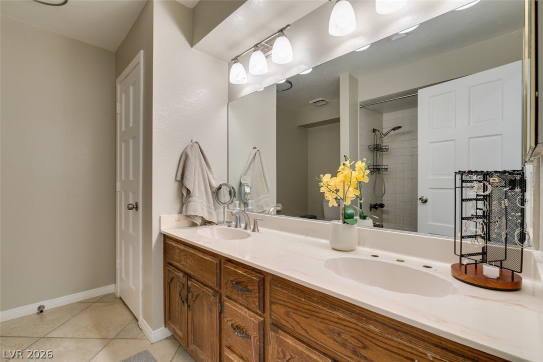 892 North Hollywood Boulevard Las Vegas, NV 89110 - Photo 39 of 81 This bathroom features a double vanity and a shower behind a sleek sliding door.