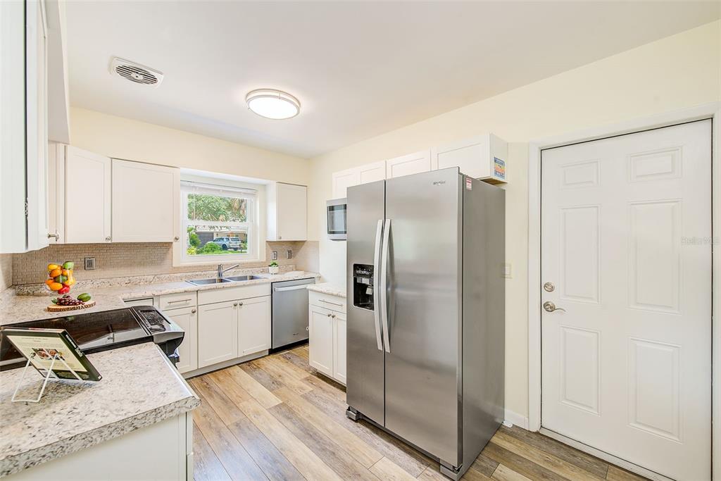 14079 Victoria Road Largo, FL 33774 - Photo 12 of 46 a kitchen with a refrigerator sink and cabinets