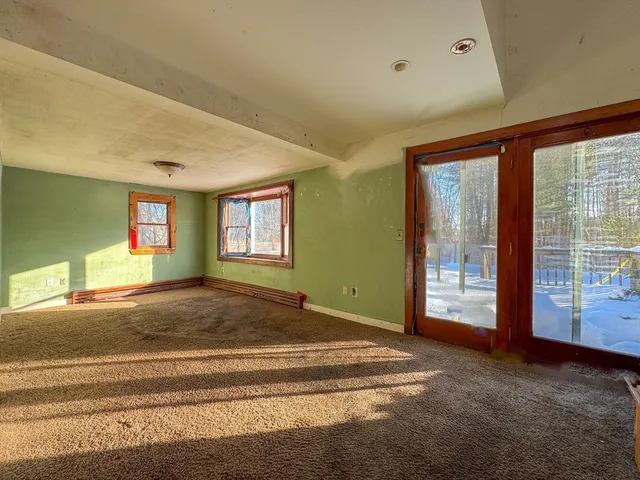 a spacious bedroom with a bed and a large window