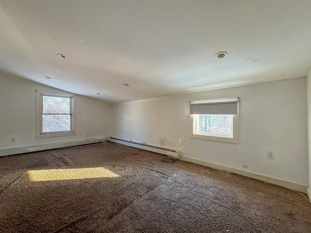 an empty room with a empty space and windows