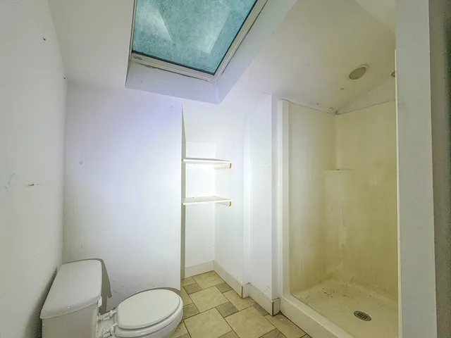 a white toilet sitting next to a bathroom sink