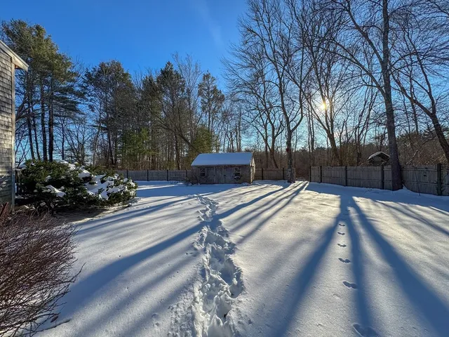 a view of a house with cars yard