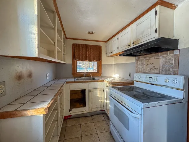 a kitchen with a stove and a sink