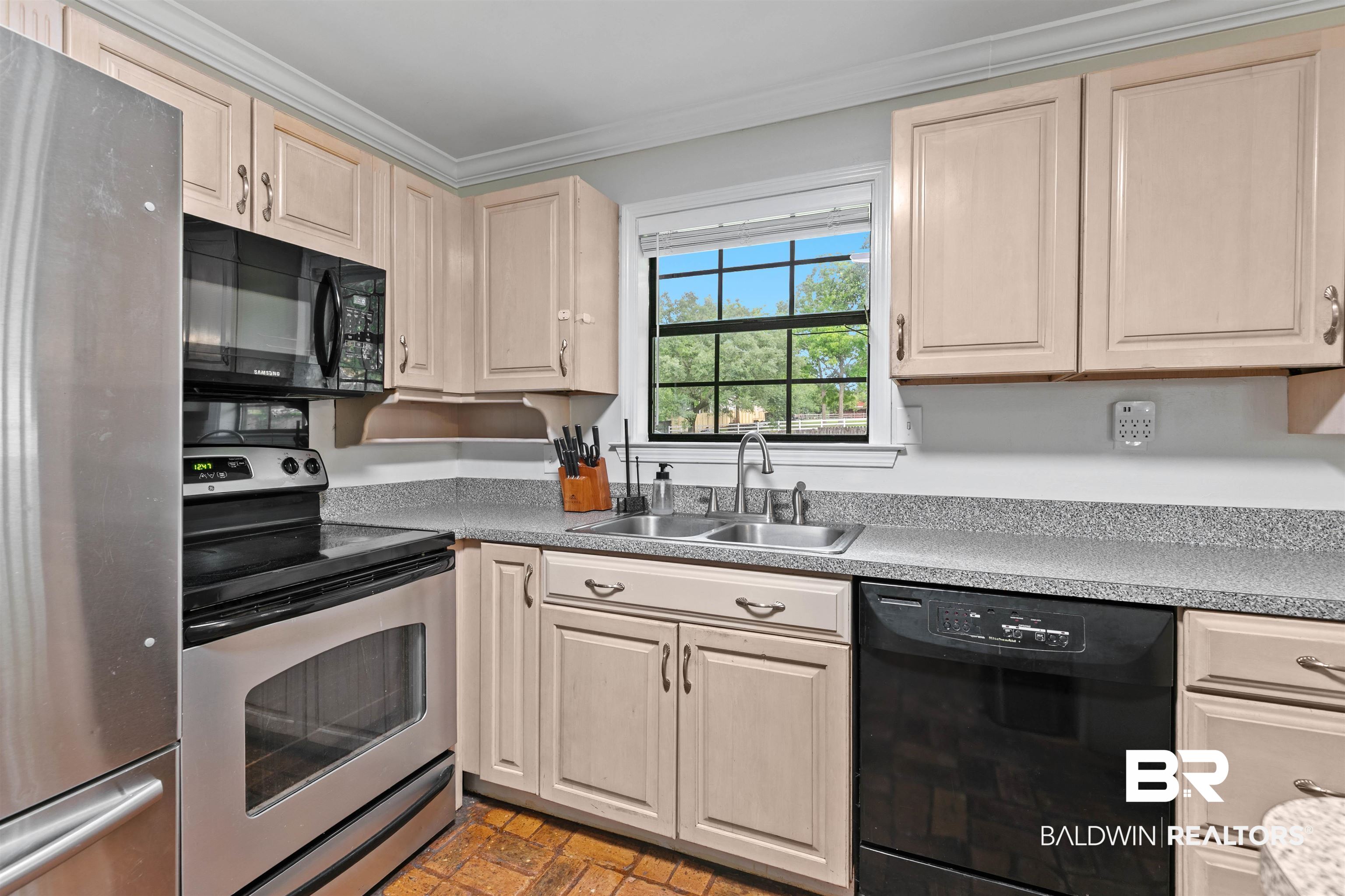 10420 Johnson Road South Mobile, AL 36695 - Photo 21 of 75 Kitchen featuring light-toned cabinetry with d-pull hardware, gray speckled countertops, stainless steel refrigerator, black range, and black built-in microwave