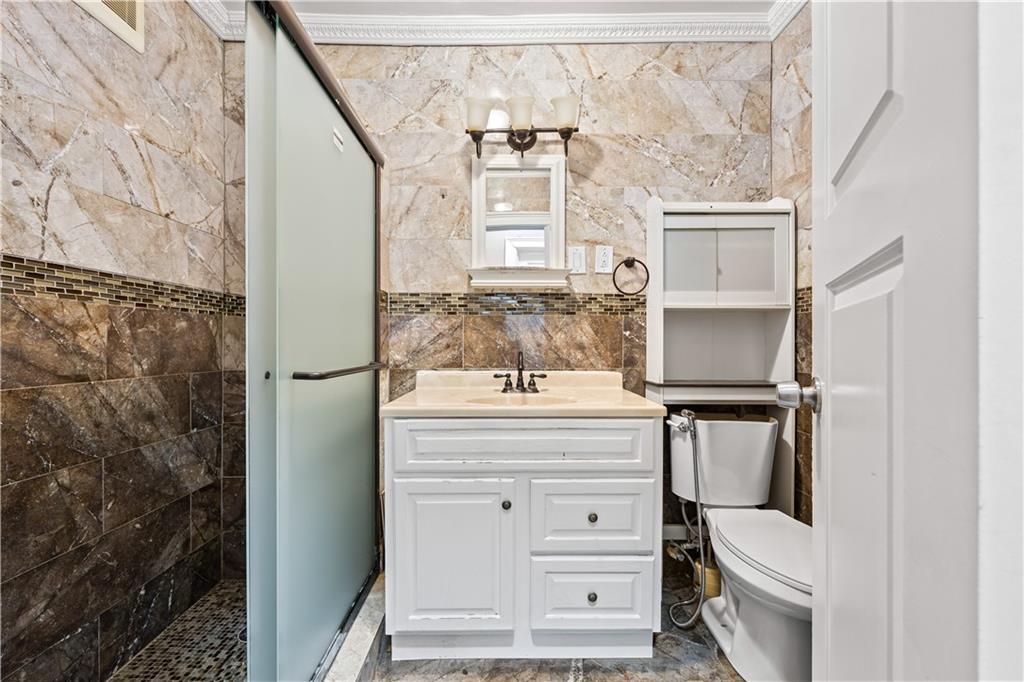 447 83rd Street Brooklyn, NY 11209 - Photo 4 of 14 a bathroom with a sink toilet and mirror