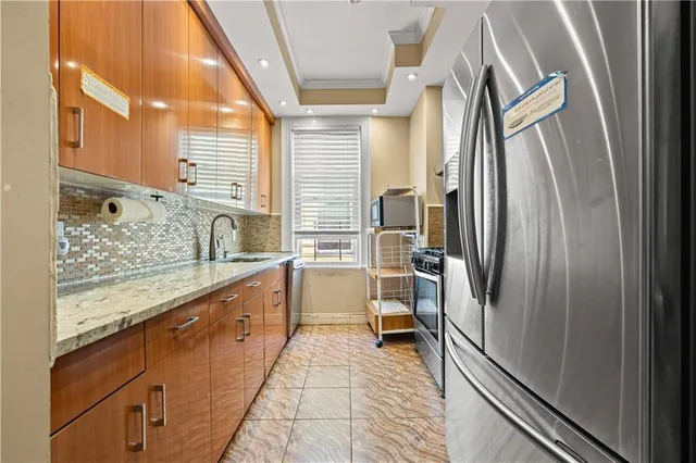 a bathroom with a granite countertop sink mirror vanity and bathtub
