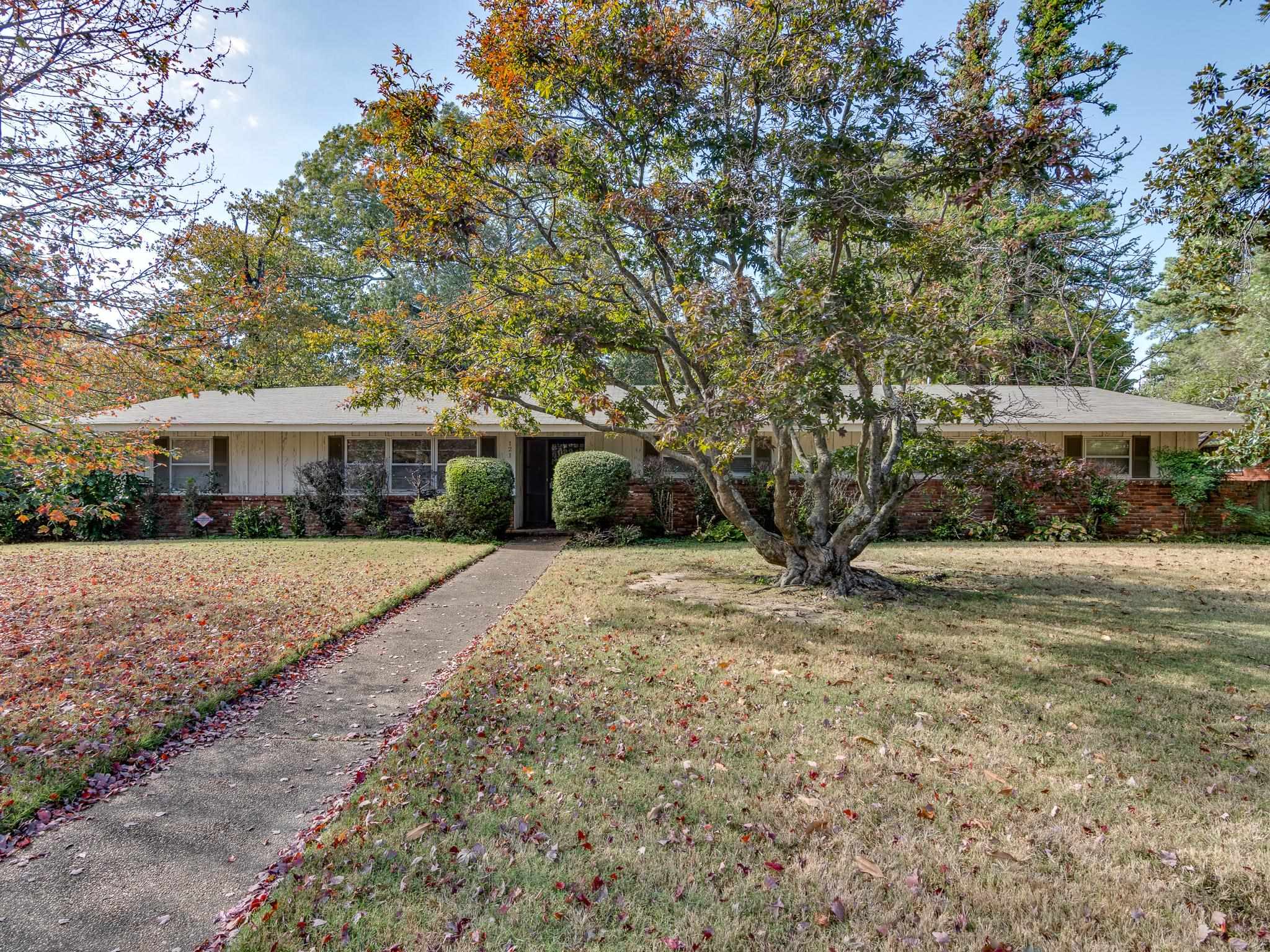 121 South Yates Road Memphis, TN 38120 - Photo 1 of 38 a front view of a house with a yard and shrubs