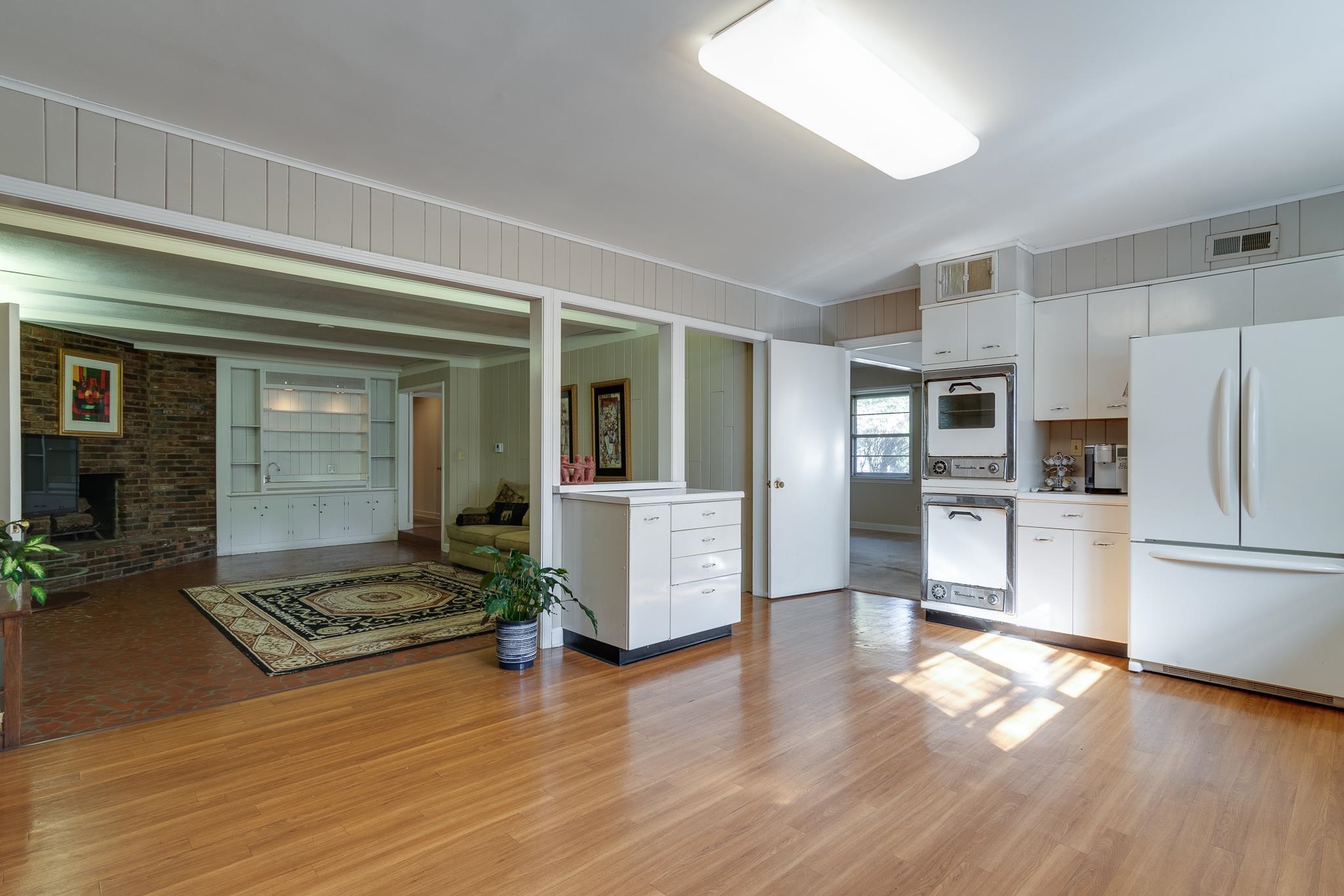 121 South Yates Road Memphis, TN 38120 - Photo 14 of 38 a view of a kitchen with refrigerator and wooden floor