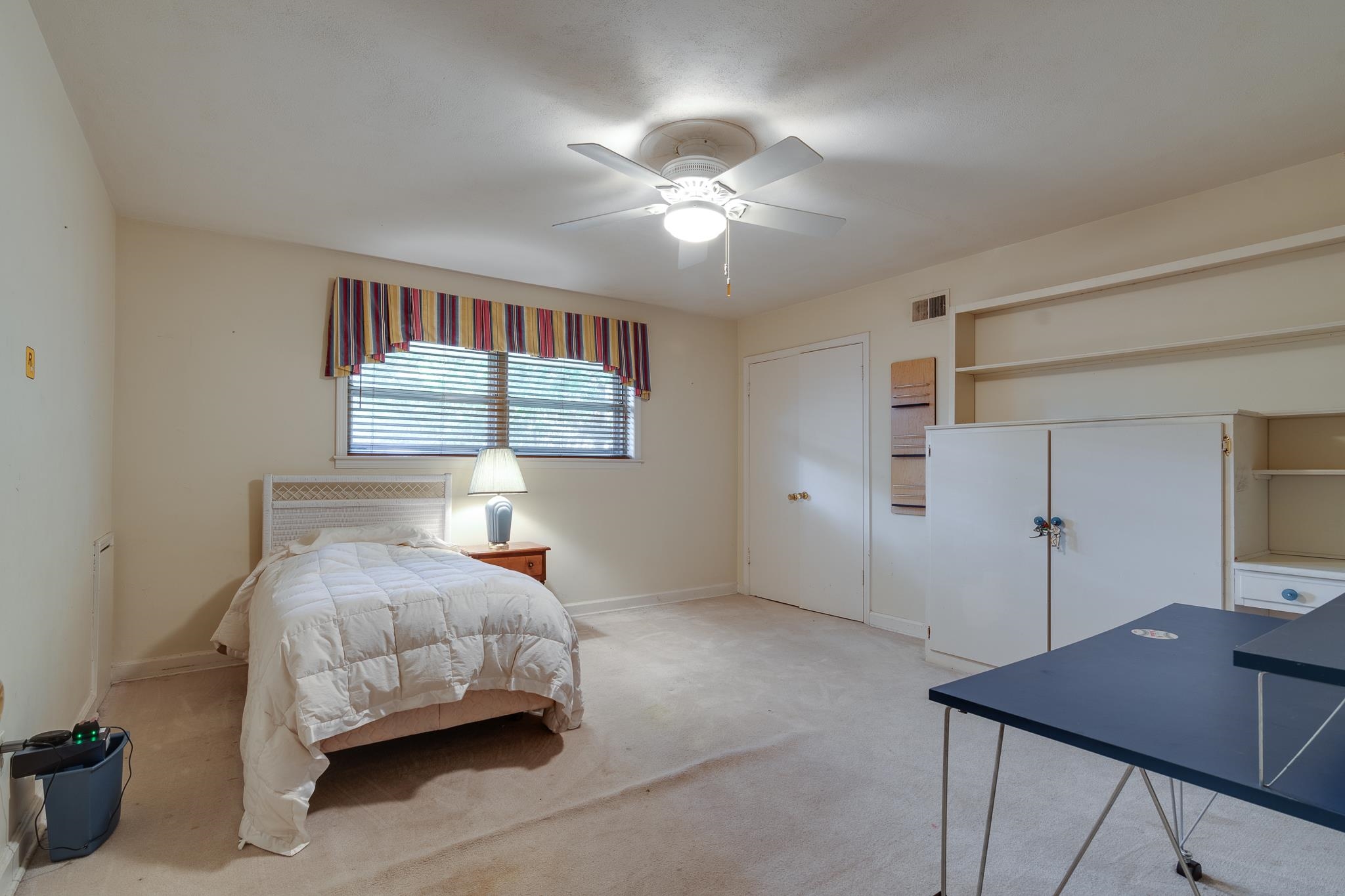 121 South Yates Road Memphis, TN 38120 - Photo 26 of 38 a bedroom with a bed and a chandelier