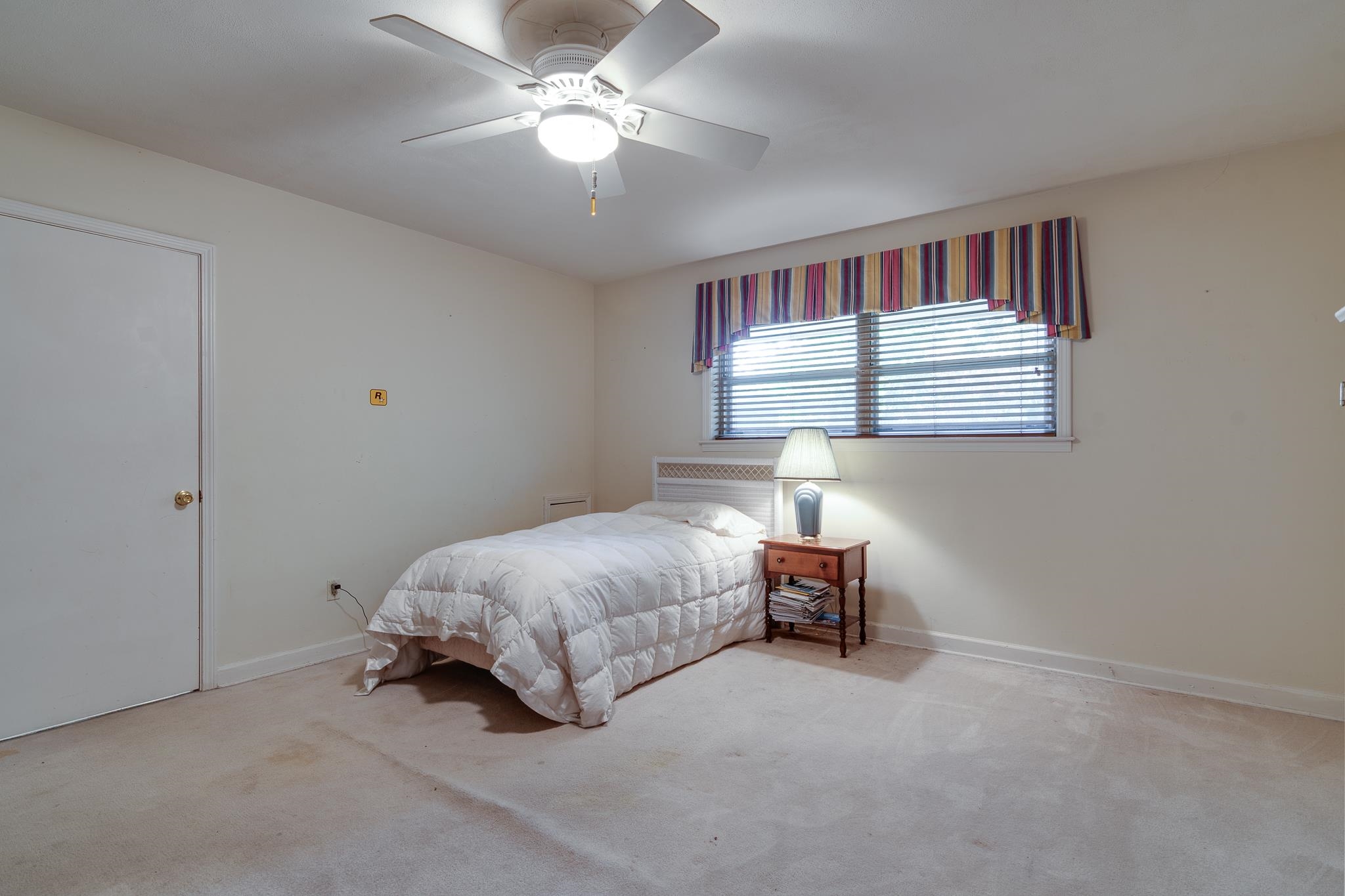 121 South Yates Road Memphis, TN 38120 - Photo 30 of 38 a spacious bedroom with a bed and a chandelier