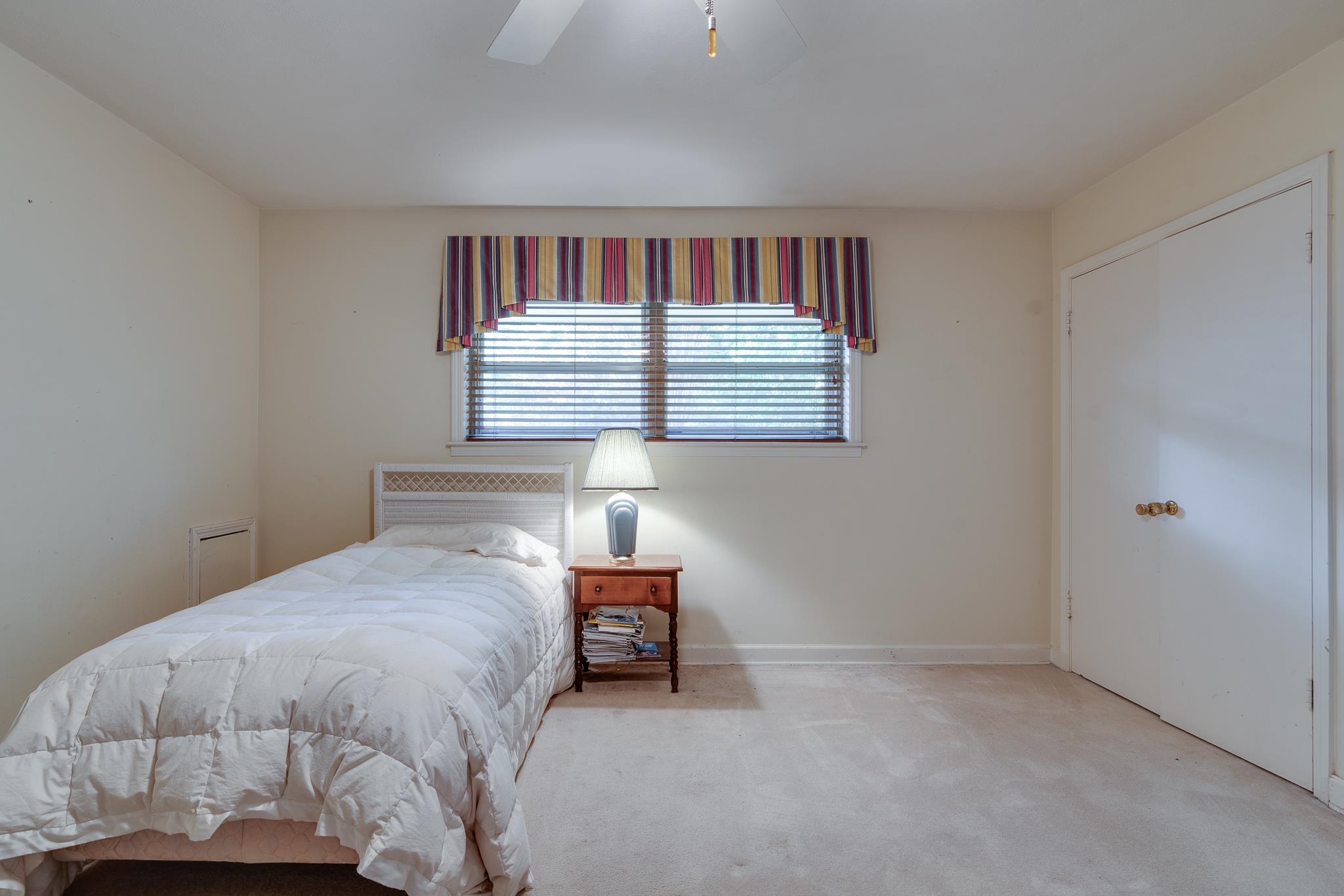 121 South Yates Road Memphis, TN 38120 - Photo 31 of 38 a bedroom with a bed and a window