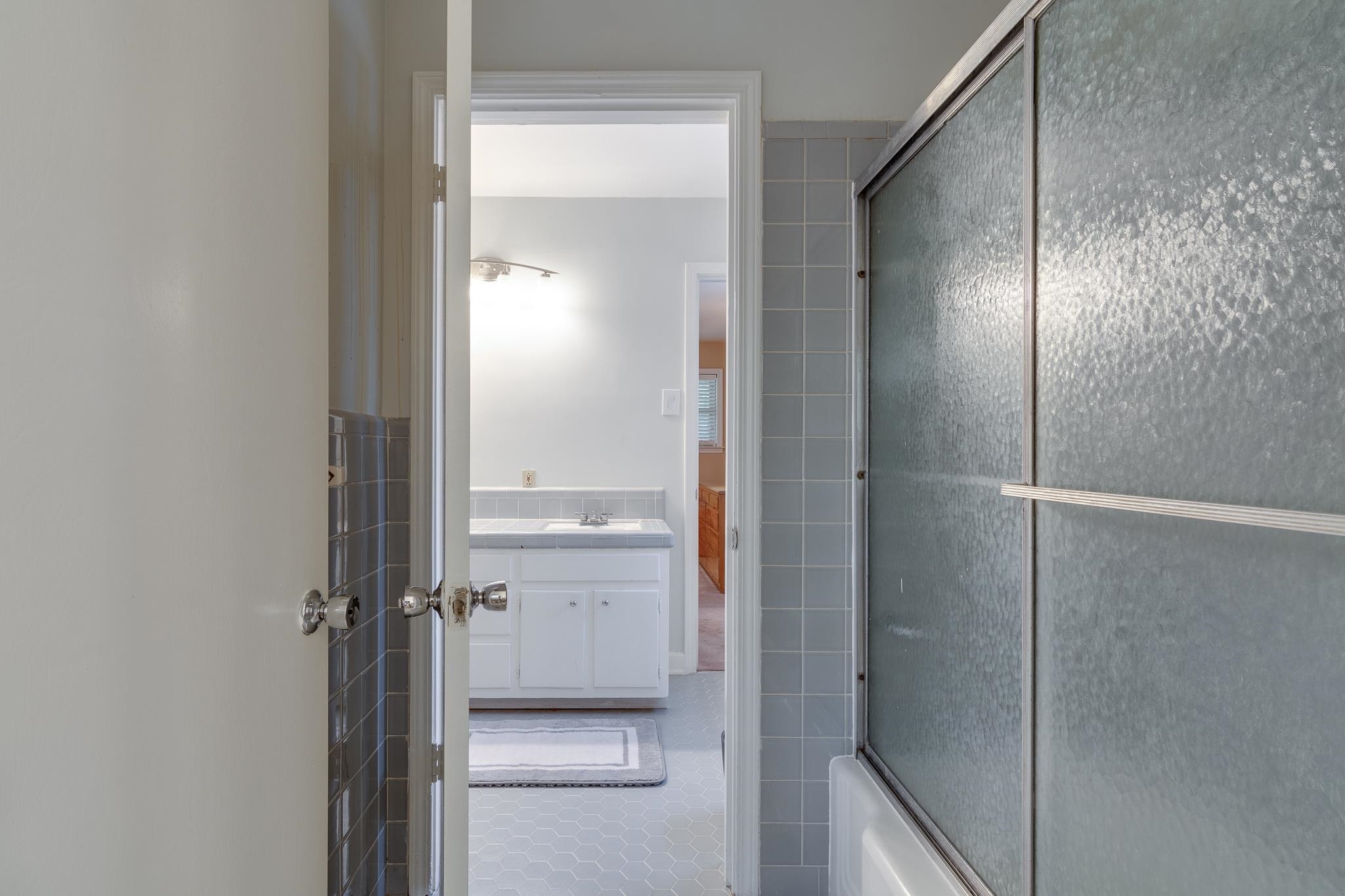 121 South Yates Road Memphis, TN 38120 - Photo 32 of 38 a bathroom with a glass shower door and a mirror