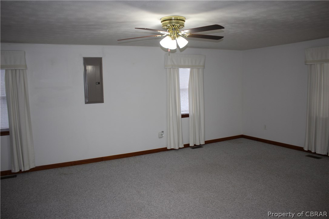 1174 North River Road Bohannon, VA 23021 - Photo 10 of 35 an empty room with windows and fan