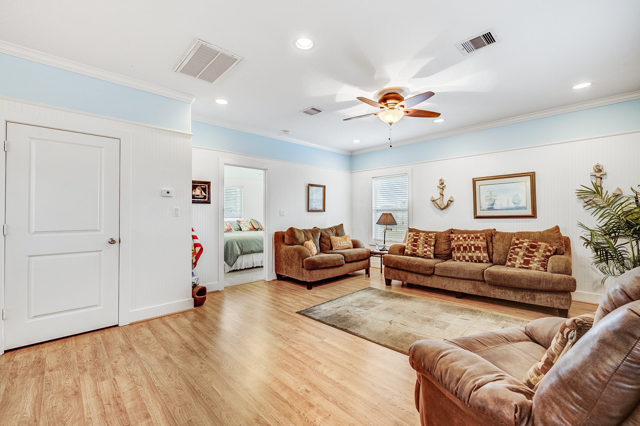 935 Clara Street Crystal Beach, TX 77650 - Photo 13 of 30 a living room with furniture and a chandelier