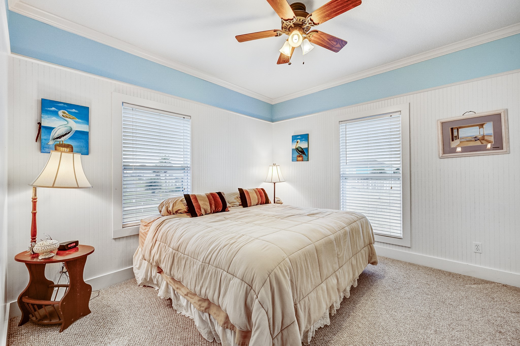 935 Clara Street Crystal Beach, TX 77650 - Photo 15 of 30 a bedroom with a bed and a chandelier