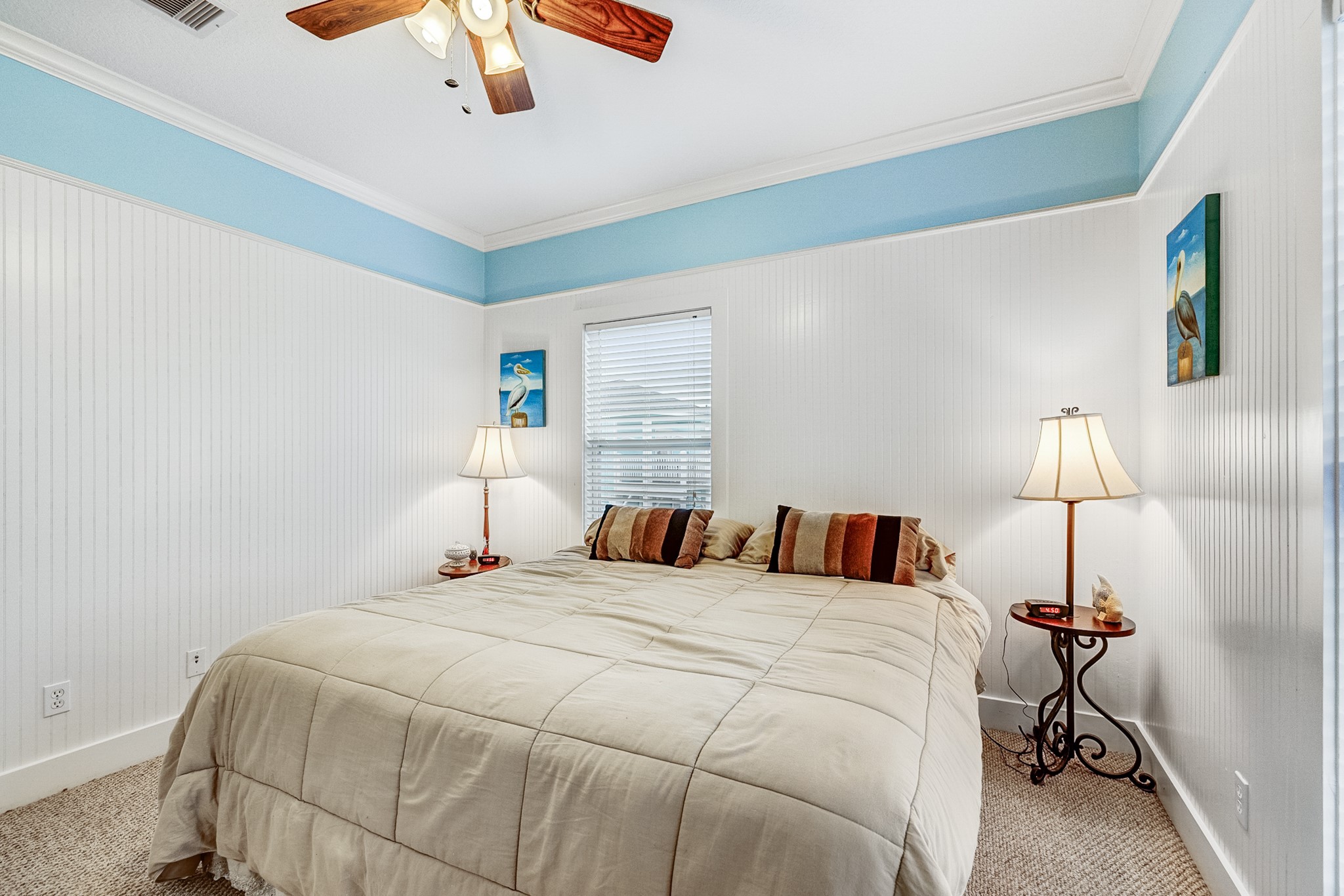 935 Clara Street Crystal Beach, TX 77650 - Photo 16 of 30 a bedroom with a bed and a lamp
