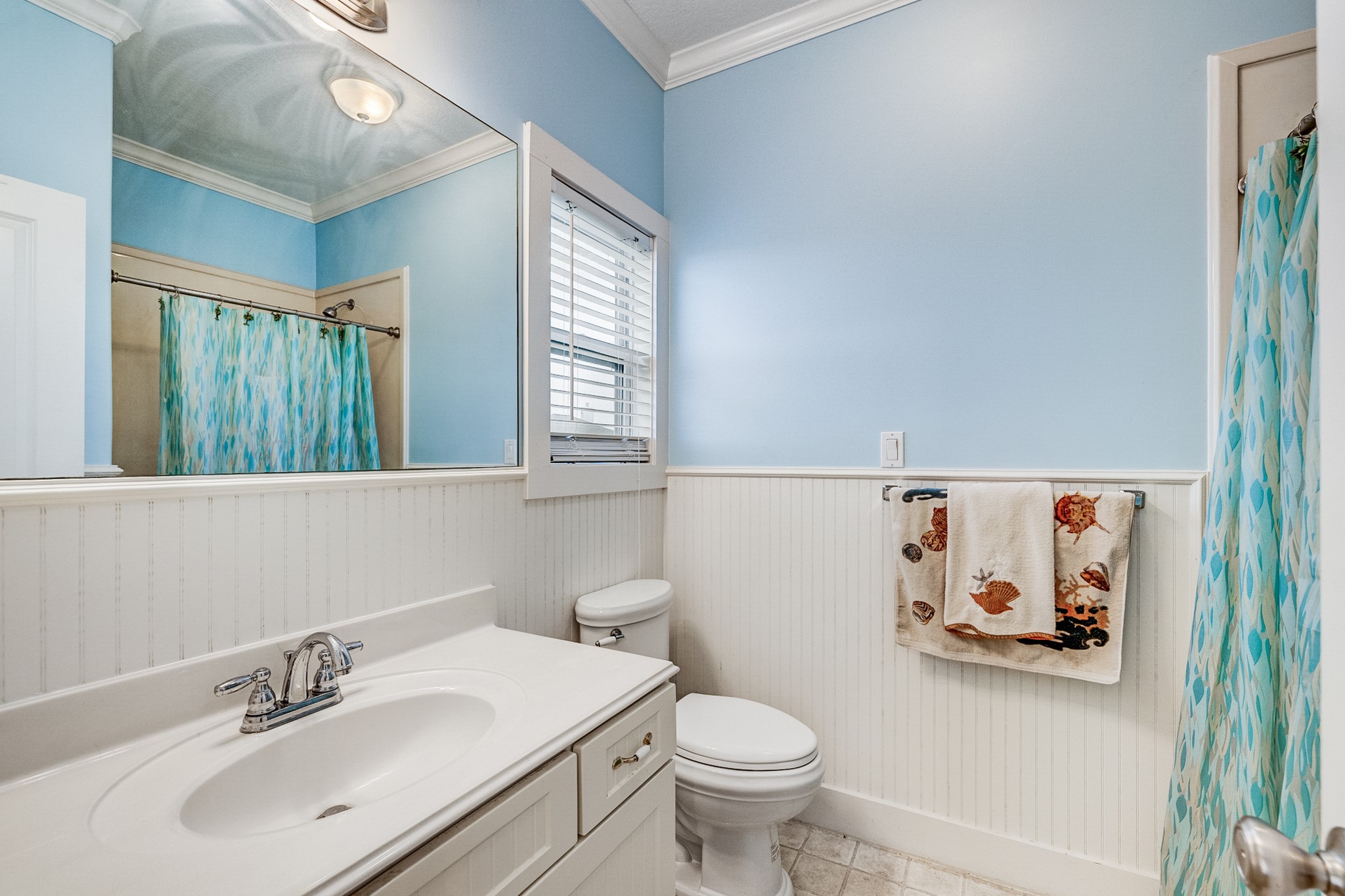 935 Clara Street Crystal Beach, TX 77650 - Photo 17 of 30 a bathroom with a toilet sink and mirror