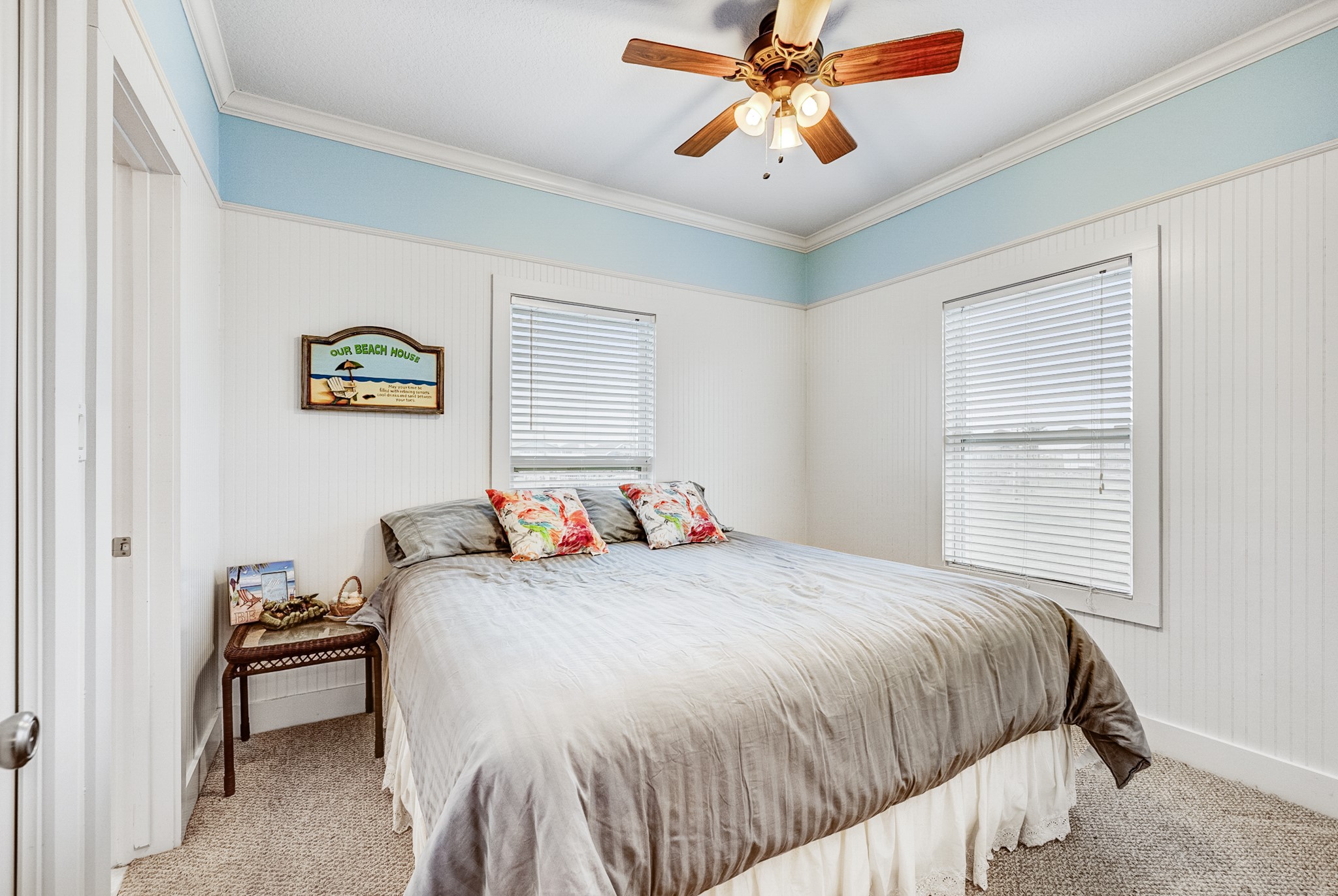 935 Clara Street Crystal Beach, TX 77650 - Photo 18 of 30 a bedroom with a bed and a chandelier