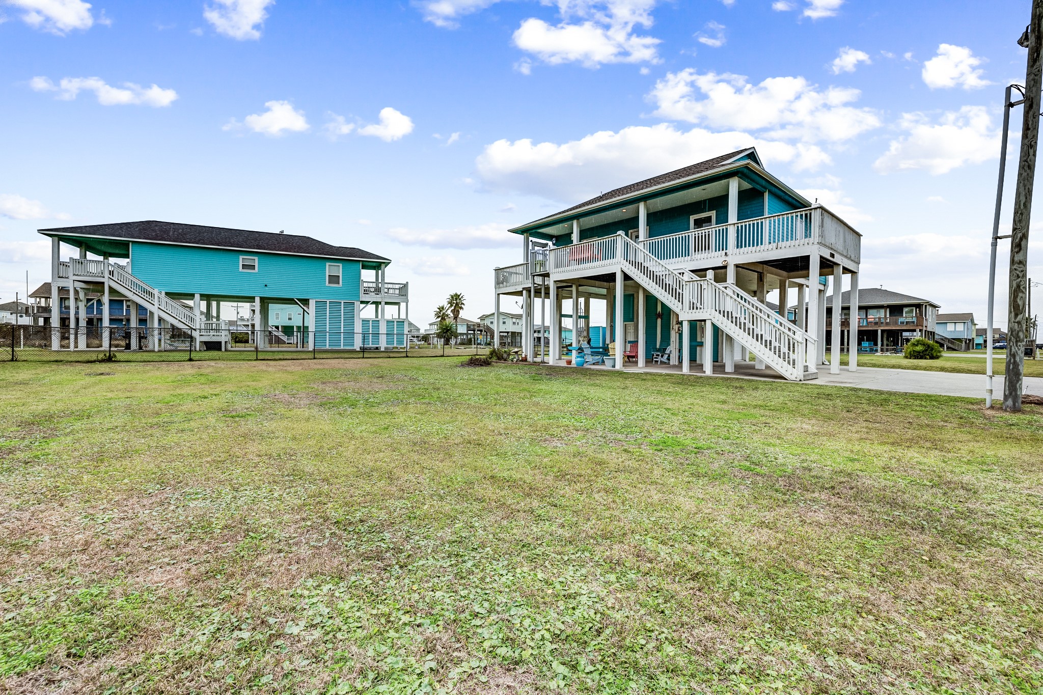 935 Clara Street Crystal Beach, TX 77650 - Photo 23 of 30 a view of a house with a big yard and large trees