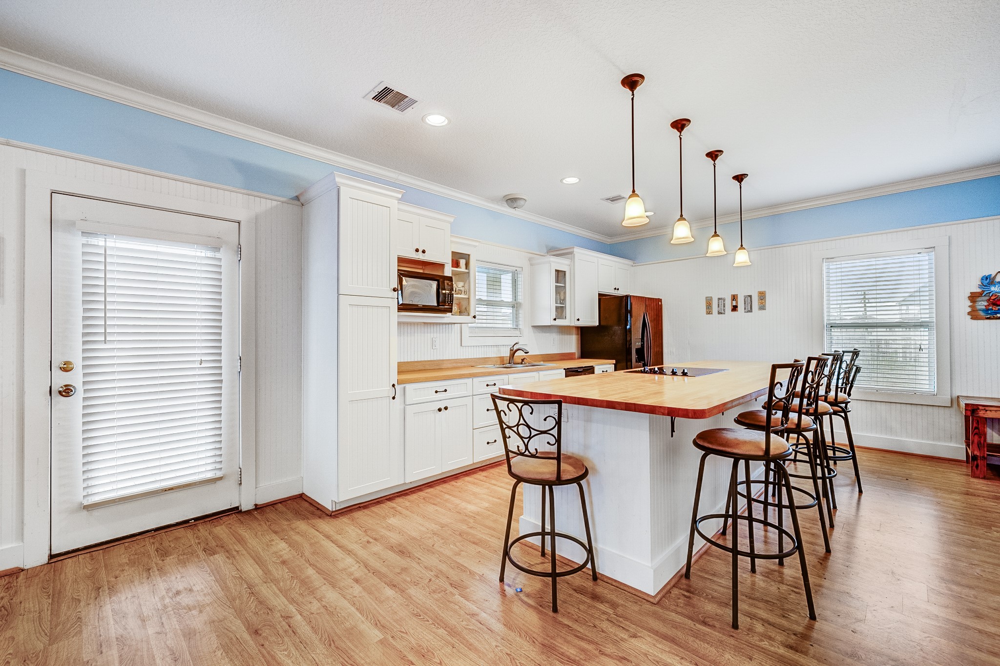 935 Clara Street Crystal Beach, TX 77650 - Photo 6 of 30 a view of a dining room with furniture and wooden floor