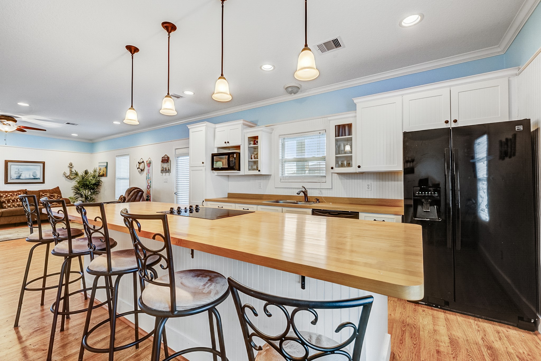 935 Clara Street Crystal Beach, TX 77650 - Photo 7 of 30 a large kitchen with a table and chairs